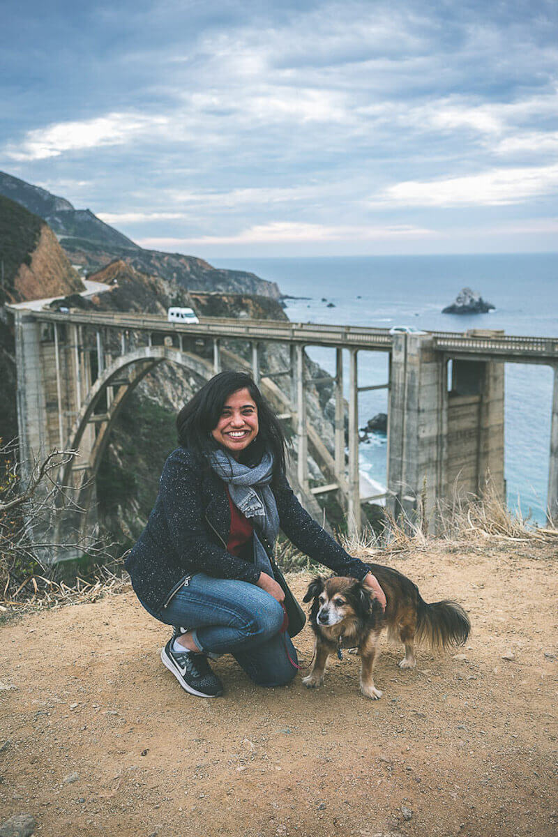 Big Sur is the best road trip from San Francisco, girl and dog at Bixby Bridge